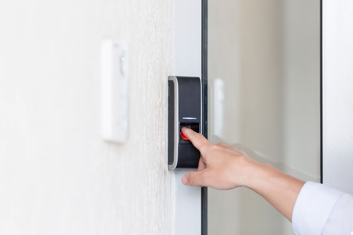 A hand pressing a door button, indicating an action to open or close the door.